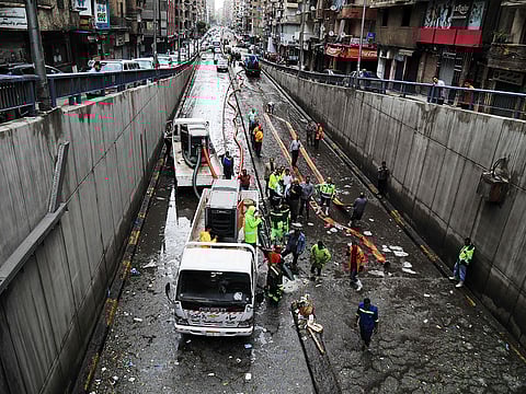 Municipal emergency service staff clear hail blocking an underpass after a windstorm struck Egypt's northern city of Alexandria on the Mediterranean coast in the early hours on May 31, 2025.