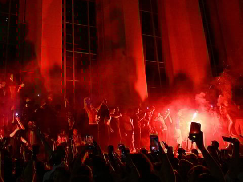 Paris Saint-Germain (PSG) supporters set off flares as they gather on Place Trocadero in front of The Eiffel Tower in Paris on May 31, 2025, during celebrations following their 5-0 victory in the UEFA Champions League final football match between Paris Saint-Germain (PSG) and Inter Milan held in Munich.