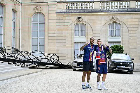Paris Saint-Germain's French defender Presnel Kimpembe (L) and French defender Lucas Hernandez thumb up as they leave after a reception at the Elysee presidential palace in Paris on June 1, 2025.