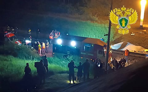 Russian law enforcement officers working at the site of a bridge collapse in the Vygonichi district of the Bryansk region.