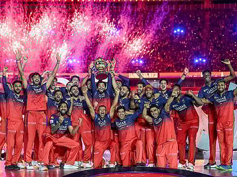 Royal Challengers Bengaluru's players celebrate with the trophy after winning the Indian Premier League 2025 crown beating Punjab Kings in the finals.