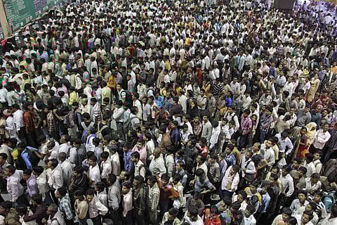 Indians crowd ticket counters at a railway station in Ahmadabad, India. The Home Ministry announced plans to conduct a two-stage count ending March 1, 2027 in a statement Wednesday night.