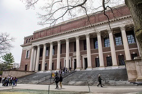 People enter and exit the Harry Elkins Widener Memorial Library on the Harvard University campus in Cambridge, Massachusetts, on April 15, 2025.