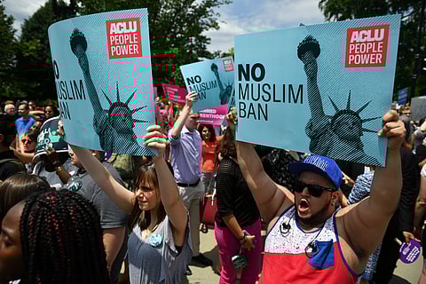 People protest the Muslim travel ban in front of the US Supreme Court in Washington, DC on June 26, 2018.