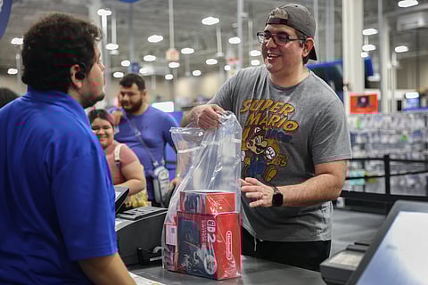 Darrell Zimmer purchases a Nintendo's Switch 2 console at a midnight opening of a Best Buy store on June 05, 2025 in Pembroke Pines, Florida.
