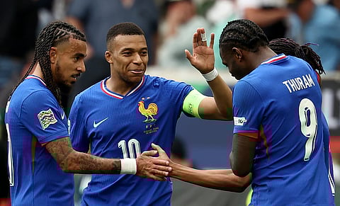 France's forward Michael Olise is congratulated by (L-R) defender Malo Gusto, forward Kylian Mbappe and forward Marcus Thuram after scoring the 0-2 goal during the UEFA Nations League third place play-off football match against France in Stuttgart, southwestern Germany on June 8.