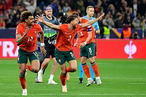 Portugal's players including Portugal's midfielder Renato Veiga and defender Ruben Dias celebrate after midfielder Ruben Neves scored the winning penalty during the UEFA Nations League final football match against Spain in Munich, southern Germany on June 8.