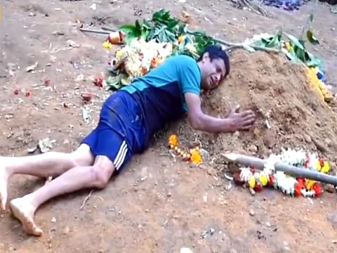 ‘I want to stay here with him’: Heartbroken father clings to son’s grave after Bengaluru stadium stampede