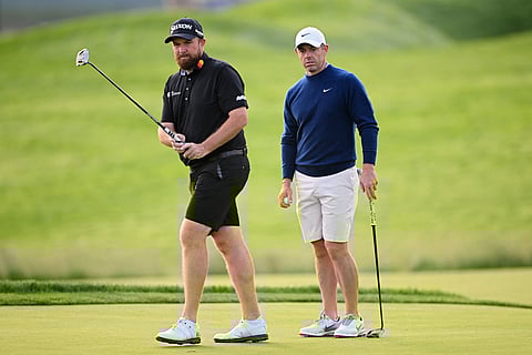 Shane Lowry of Ireland (L) and Rory McIlroy of Northern Ireland putt on the 11th green during a practice round prior to the 125th U.S. OPEN at Oakmont Country Club on June 10 in Oakmont, Pennsylvania.