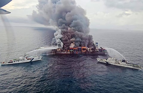 This handout photograph taken and released on June 10, 2025 by the Indian Coast Guard (ICG) shows smoke billowing from Singapore-flagged container ship MV Wan Hai 503 that caught fire 78 nautical miles off Beypore port in India's Kerala state.
