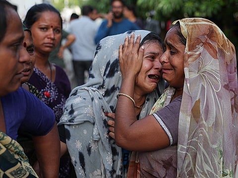 A family member cries upon hearing the news of her brother who died when the Air India Boeing 787 Dreamliner plane crashed in Ahmedabad, on Thursday.