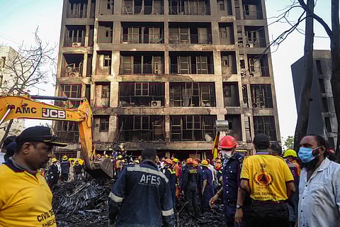 Rescue officials work at the site where Air India flight 171 crashed in a residential area near the airport in Ahmedabad on June 12, 2025.