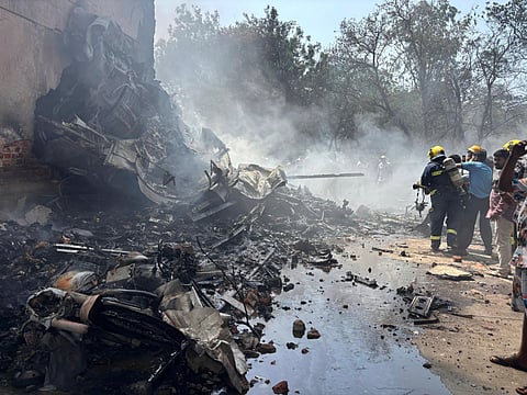 Firefighters work at the site where an Air India airplane crashed in Ahmedabad.