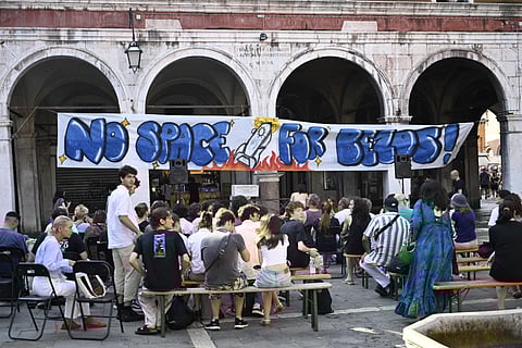 People gather to protest against the wedding of Amazon Founder and CEO Jeff Bezos and journalist Lauren Sanchez in Venice, on June 13, 2025.