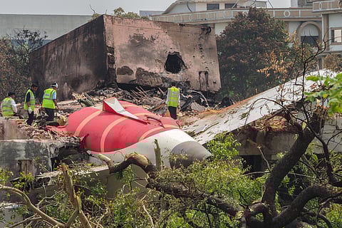 An investigation team inspects the wreckage of Air India flight 171 a day after it crashed in a residential area near the airport, in Ahmedabad on June 13, 2025.