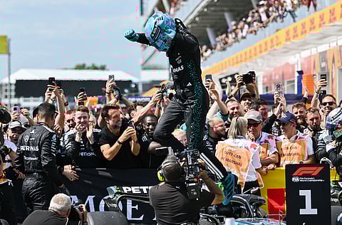 Mercedes driver, Britain's George Russell jumps off his car after winning the F1 Canadian Grand Prix auto race in Montreal, Sunday, June 15, 2025.