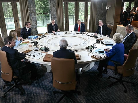 (L/R, clockwise) Japan's Prime Minister Shigeru Ishiba, Italy's Prime Minister Giorgia Meloni, French President Emmanuel Macron, Canadian Prime Minister Mark Carney, US President Donald Trump, British Prime Minister Keir Starmer, German Chancellor Friedrich Merz, European Commission President Ursula Von der Leyen, and European Council President António Costa attend a working session during the Group of Seven (G7) Summit at the Pomeroy Kananaskis Mountain Lodge in Kananaskis, Alberta, Canada.