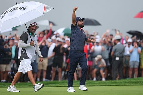 Spaun of the United States celebrates with caddie Mark Carens after winning on the 18th green during the final round of the 125th US OPEN at Oakmont Country Club on June 15.