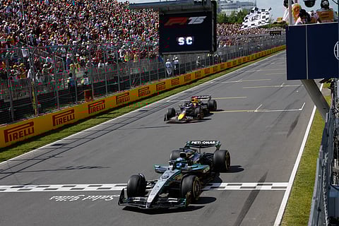 Mercedes' British driver George Russell crosses the finish line as he wins the race, followed by Red Bull Racing's Dutch driver Max Verstappen in second place, during the 2025 Formula 1 Grand Prix du Canada at Circuit Gilles-Villeneuve in Montreal, Canada, on June 15, 2025.