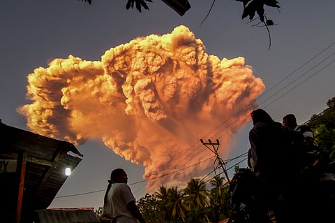 Dozens of flights to and from Indonesia's resort island of Bali were cancelled on Wednesday, according to authorities and the island's airport, after a volcano in the archipelago's east erupted, shooting an ash tower 10 kilometres into the sky.