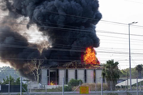 Smoke billows from a fire in a building in Herzliya near Tel Aviv following a fresh barrage of Iranian rockets on June 17, 2025. Israel's military said air raid sirens sounded in several areas of the country on June 17 after identifying missiles launched from Iran, as AFP journalists reported booms over Tel Aviv and Jerusalem