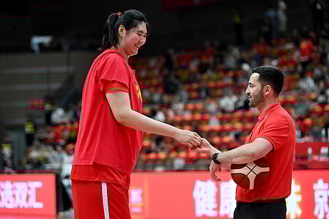 China's Zhang Ziyu and an umpire gesture prior to play against Japan during a warm-up game ahead of the FIBA Women's Asia Cup in Xian, China's central Shaanxi province on June 18.