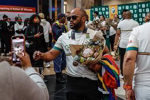 Captain of the South Africa men's Cricket Team, the Proteas, Temba Bavuma reacts as he arrives with the rest of the team at the O.R. Tambo International Airport in Kempton Park on June 18, 2025 after winning the International Cricket Council (ICC) World Test Championship at Lord's.