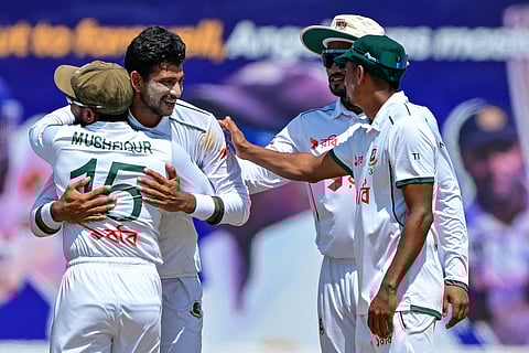 Bangladesh's Nayeem Hasan (2L) celebrates with teammates after taking a five-wicket haul during the fourth day of the first Test cricket match between Sri Lanka and Bangladesh in Galle.