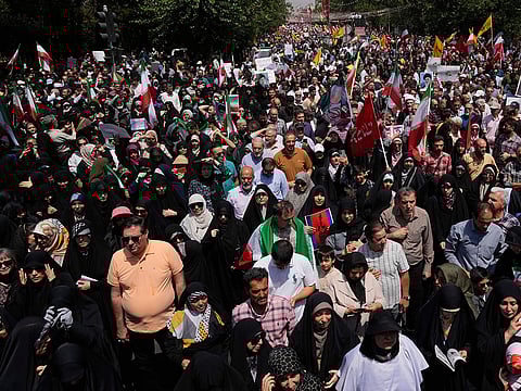 Iranian worshippers attend a protest to condemn Israeli attacks on multiple cities across Iran, after the Friday prayers ceremony in Tehran, Iran, Friday, June 20, 2025.