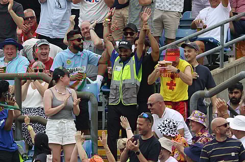 A security guard celebrates in the crowd after catching a six hit by India's Rishabh Pant on day two of the first cricket test match against England at Headingley cricket ground in Leeds, northern England on June 21, 2025.