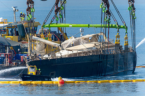The hull of the superyacht Bayesian is pulled out of the sea and dewatered off the village of Porticello.