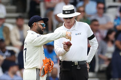 India's Rishabh Pant (L) complains about the shape of the ball to Australia's umpire Paul Reiffel (R) on day three of the first cricket test match between England and India at Headingley cricket ground in Leeds, northern England on June 22, 2025.