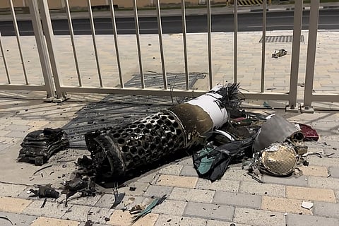This frame grab take from AFPTV footage shows the remnants of an Iranian missile intercepted over Qatar, as it lies on a pavement near a fence on June 23, 2025.