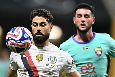 Manchester City's defender Josko Gvardiol eyes the ball next to Al Ain's midfielder Chadli Nassim during the FIFA Club World Cup 2025 Group G football match at the Mercedes-Benz stadium in Atlanta on June 22, 2025.