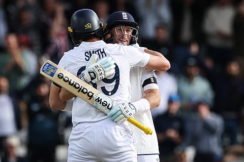 England's Joe Root (rear) and Jamie Smith celebrate winning the first cricket Test against India at Headingley, on June 24, 2025.