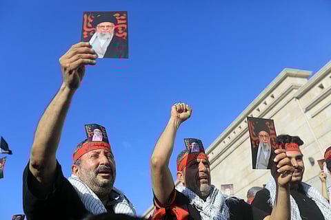 Supporters of Lebanon's Hezbollah hold pictures Iran's supreme leader Ayatollah Ali Khamenei, during a rally outside the Iranian Embassy in Beirut’s southern suburbs, to celebrate a ceasefire between Israel and Iran, on June 25, 2025.
