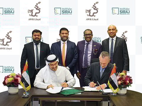 Sitting from left: Ahmed Khalaf Al Otaiba and Alexander Wood sign the MoU; From left (top row): Ahamed Khan, Mohamed Rusan Fyroze, Udaya Indrarathna, Charaka Sumanasekara