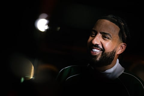 Moroccan-US rapper French Montana smiles during a visit to a gym in Paris, on June 25, 2025.