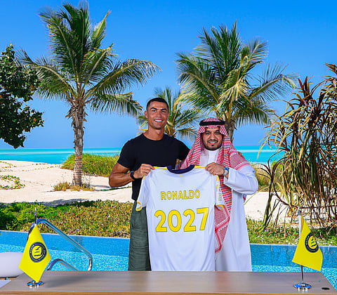 Cristiano Ronaldo (left) poses with club chairman Abdullah Al Majid after signing a new deal with the Saudi club at an undisclosed location.