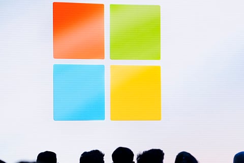 FILE - A Microsoft logo is seen on a screen as people listen at an event at Microsoft headquarters, May 20, 2024, in Redmond, Wash. (AP Photo/Lindsey Wasson, File)