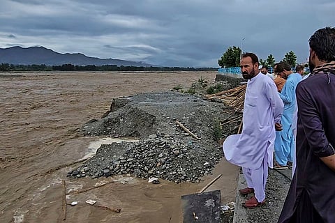 Local residents look to the Swat River, which is overflowing due to pre-monsoon heavy rains in the area, on the outskirts of Mingora, the main town of Pakistan's Swat Valley, Friday, June 27, 2025.