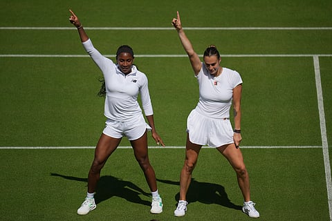 Aryna Sabalenka (right) of Belarus and Coco Gauff of United States dance during a practice session ahead of the Wimbledon Championships in London on June 27, 2025.