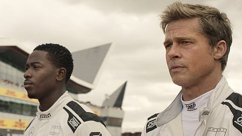 This image released by Apple TV+ shows Damson Idris as Joshua Pearce, left, and Brad Pitt as Sonny Hayes in a scene from "F1 The Movie." (Apple TV+ via AP)