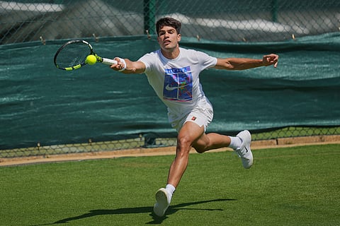 Carlos Alcaraz of Spain plays a return during a practice session ahead of the Wimbledon Championships in London, Friday, June 27, 2025.