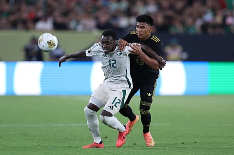 Saud Abdulhamid (left) of Saudi Arabia battles for the ball with Jesús Gallardo of Mexico during the 2025 CONCACAF Gold Cup quarterfinal in Glendale, Arizona, on June 28, 2025.
