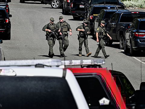 Police and fire crews respond to a shooting and fire on Canfield Mountain in Coeur d'Alene, Idaho.