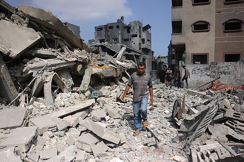 A Palestinian man walk next to the rubble of a residential house that was hit in overnight Israeli strikes in Jabalia in the northern Gaza Strip, on June 30, 2025, as the war between Israel and the Hamas Islamist militant movement continues.