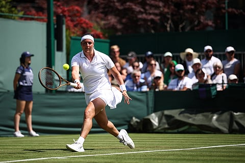 Tunisia's Ons Jabeur plays a forehand return to Bulgaria's Viktoriya Tomova during their women's singles first round tennis match on the first day of the 2025 Wimbledon Championships at The All England Lawn Tennis and Croquet Club in Wimbledon, southwest London, on June 30, 2025.