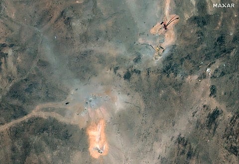 This handout satellite image provided by Maxar Technologies and dated July 1, 2025, shows activity near the holes caused by the June 22 US airstrike on the Fordo (Fordow) Fuel Enrichment Plant complex, about 30 kilometres north of Qom in central Iran.