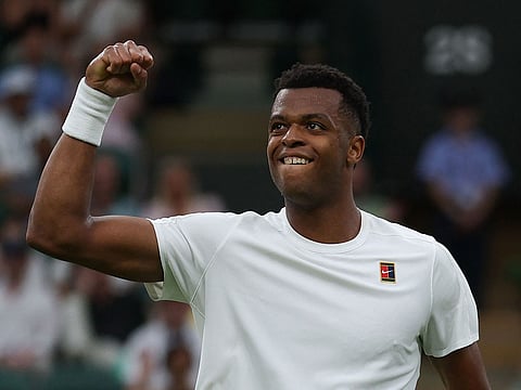 France's Giovanni Mpetshi Perricard reacts as he plays against US Taylor Fritz during their men's singles first round tennis match on the first day of the 2025 Wimbledon Championships.
